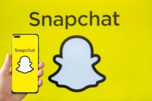 Zhongshan,China-july,6,2023:hand,Holding,A,Mobile,With,Snapchat,Logo,At